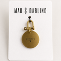 Brass keychain with 'Vinnie' engraved on a 'Mad & Darling' branded card.